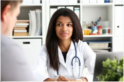 Medical provider consulting with a male patient about functional health analysis, life coaching, and personalized wellness strategies at Bella Medical Associates in Albemarle NC.