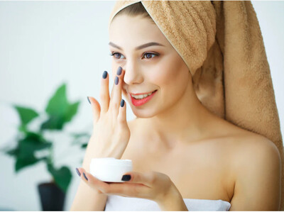 Woman applying skincare products symbolizing PCA, GlyMed, and DefenAge treatments for skin, hair growth, nail health, and beauty care at Bella Medical Associates in Albemarle NC, offering urgent care and wellness coaching.