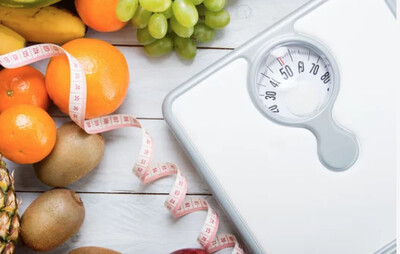 Scale symbolizing WeighTOGO Pillars of Health holistic weight loss program focused on nutrition, movement, mindset, and longevity at Bella Medical Associates.