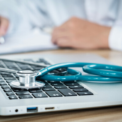 Computer and stethoscope symbolizing virtual visits with functional medicine in Albemarle NC for hormone therapy, burnout, personalized wellness solutions, PTSD and qualifying medical cannabis evaluations at Bella Medical Associates.