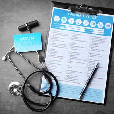 Stethoscope, clipboard, pen, and lab test kit representing qualifying medical cannabis evaluations and cannabis strain testing for the Eastern Band Cherokee Indian Program in North Carolina at Bella Medical Associates.